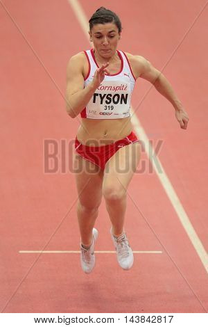 LINZ, AUSTRIA - FEBRUARY 6, 2015: Abbi Tyson (#319 Great Britain) competes in the women's 60m event in an indoor track and field event.