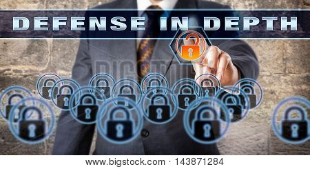 Manager is pressing DEFENSE IN DEPTH on a virtual control screen. Information assurance concept and technology metaphor for a computer network defense strategy using multiple layers of security.
