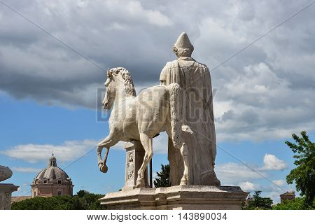 Ancient roman statue of Dioskouri against cloudy sky on Capitol Hill in Rome