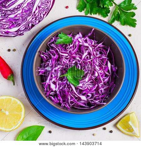 Purple cabbage salad and ingredients on a bright background. Top view