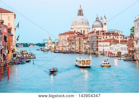 View on illuminated Grand canal with Santa Maria basilica from Accademic bridge at the dusk in Venice. Long exposure image technic