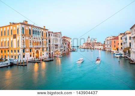 View on illuminated Grand canal with Santa Maria basilica from Accademic bridge at the dusk in Venice. Long exposure image technic