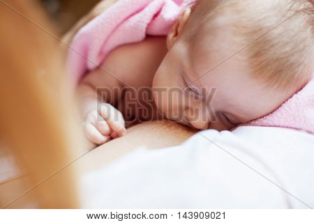 Brestfeeding. Mother with newborn at home.