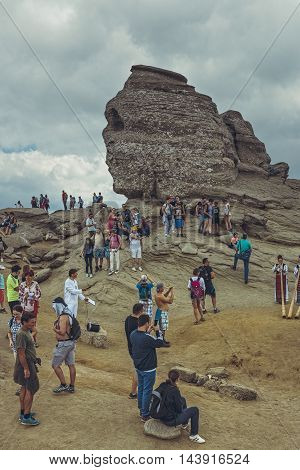 Bucegi Mountains Romania - August 6 2016: Thousands of people hike to Sphinx (Romanian: Sfinxul) the ancestral megalith with human face resemblance situated at 2216 m altitude in Bucegi Mountains.