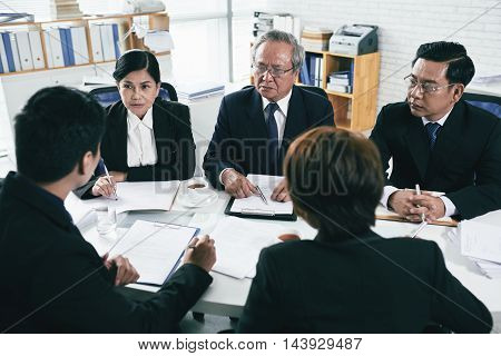 Group of lawyers negotiations during pretrial settlement