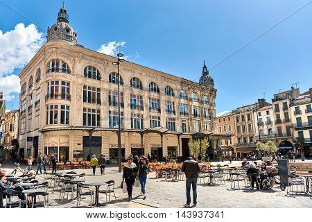 Narbonne France - April 8, 2016: People walking in a city main square in Narbonne Languedoc-Roussillon. France