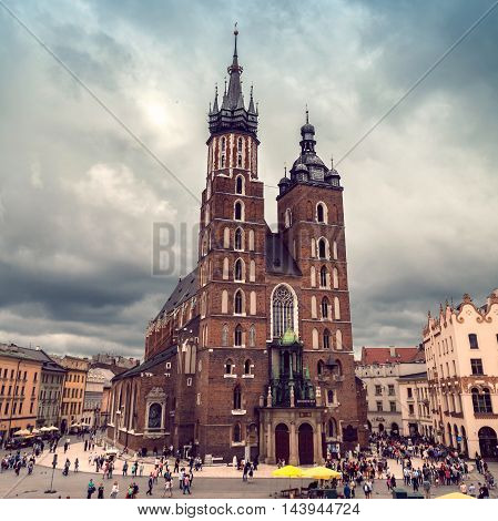 Church of St. Mary in the main Market Square in cloudy weather. Basilica Mariacka. Dramatic sky. Krakow. Poland.