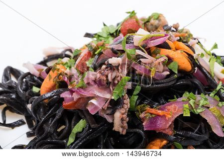 Close uyp of Black spaghetti with seafood and vegetables