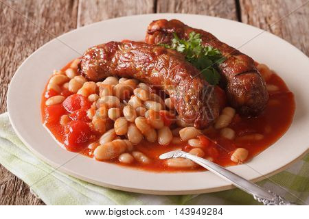 Sausages With Beans In Tomato Sauce On A Plate Close-up. Horizontal