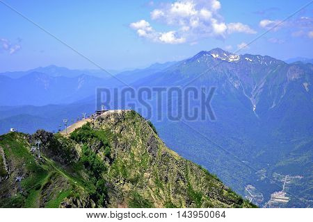 panoranic mountain landscape. valley with stones in grass on top of the hillside of mountain range in sunset light