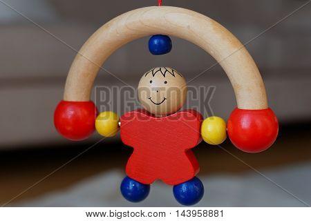 Baby wood toy - red rolling man