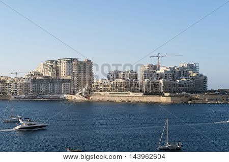 Sliema, Malta - August 02 2016: Modern Sliema skyline at Tigne Seafront. Modern apartment blocks and Tigne point bridge on Sliema's coastline.