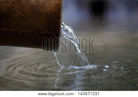 Macro photo of a water stream on a well.