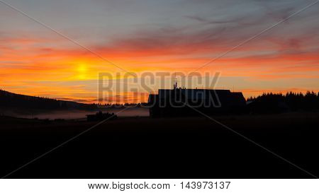 Dark silhouette of mountain hut at sunset time, Jizera Mountains, Czech Republic