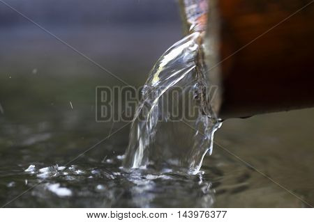 Macro photo of a water stream on a well.