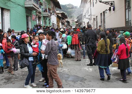 Cajamarca Peru - February 7 2016: Large group of spectators wait in street between buildings for Carnival parade in Cajamarca Peru on February 7 2016