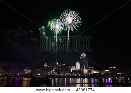 Fireworks bursting over the city of Cincinnati and the Ohio River during the 4th of July celebration 2015 Cincinnati Ohio USA