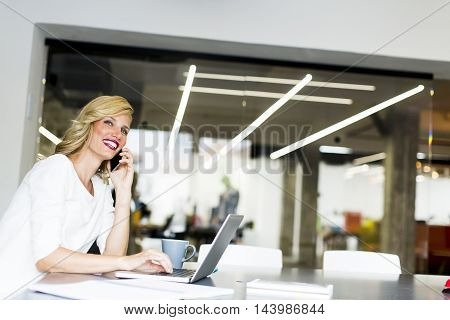 Manageress With Mobile Phone In Office