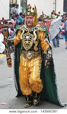 Cajamarca Peru - February 7 2016: Man dressed in gold king costume marches in Carnival parade in Cajamarca Peru on February 7 2016