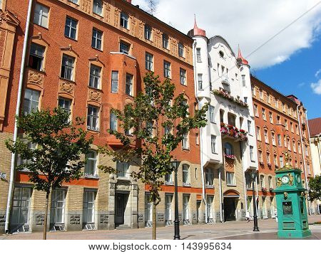 Old beautiful building and street clock. Summer.
