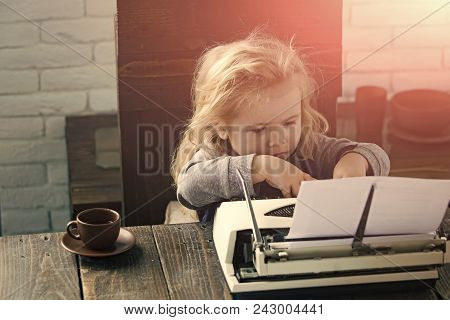 Happy Kid Having Fun. Small Boy Or Businessman Child Sitting At Table And Typing Typewriter With Pap