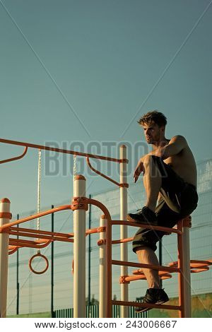 Mens Heals Body Care. Freedom, Success, Energy Concept. Sportsman With Bare Torso On Monkey Bars Top