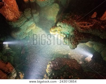 A Wishing Well With Water In Cave Or Cavern With Coins