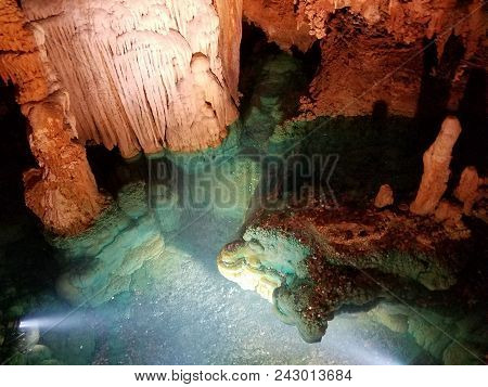 A Wishing Well With Water In Cave Or Cavern With Coins