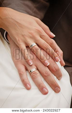 Groom With The Bride Holding Hands Together With Wedding Rings