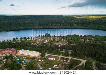 Svir river and summer green forests of Leningrad region, Russia. Bird's eye view of an urban-type settlement.