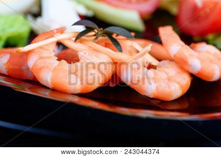 Fresh Salad From Different Vegetables And Tasty Shrimps In A Plate On The Table