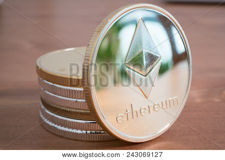 Pile Of Real Coin Of Cryptocurrency Silver Ethereum On Wooden Background