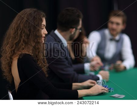 luckiest woman on the background of the players in the casino.
