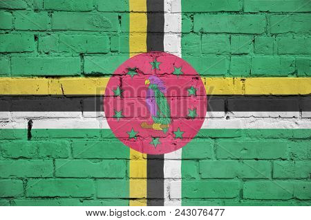 Dominica Flag Is Painted Onto An Old Brick Wall