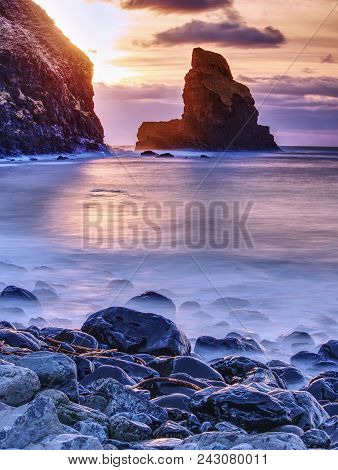 Amazing Sunset, Talisker Bay On The Isle Of Skye In Scotland. Foamy Sea, Boulders And Large Cracked 