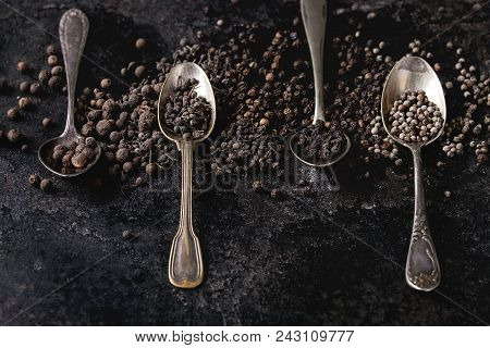 Variety Of Different Black Peppers Allspice, Pimento, Monks Pepper, Peppercorns In Vintage Spoons Ov