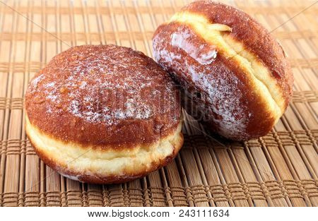 Homemade Doughnuts With Jelly Filled And Powdered Sugar On Bamboo Tablecloth. Selective Focus