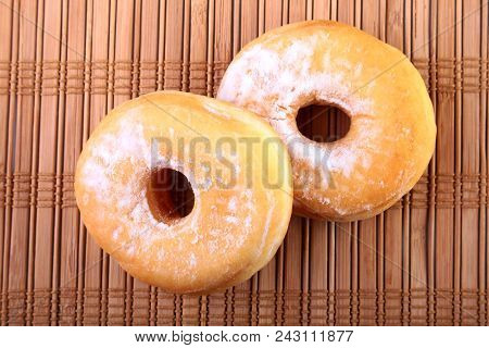 Homemade Doughnuts With Jelly Filled And Powdered Sugar On Bamboo Tablecloth. Selective Focus
