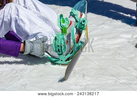 Female Snowboarder Sitting On The Snow Wears Snowboard Equipment, Enjoying Stunning View Of Winter M