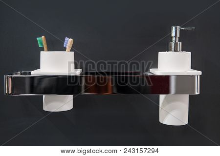 Toothbrush Holder And Liquid Soap On Holder On Bathroom Wall