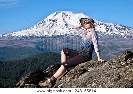 Summer Vacation Travel In Oregon. Middle Age Woman Relaxing On Mountain Top By Glacier On Mount Adam