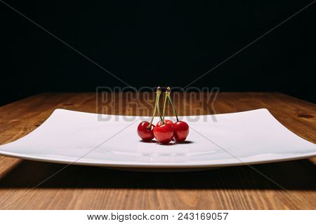 Fresh Cherry On Plate On Wooden Blue Background. Fresh Ripe Cherries. Sweet Cherries. Close Up