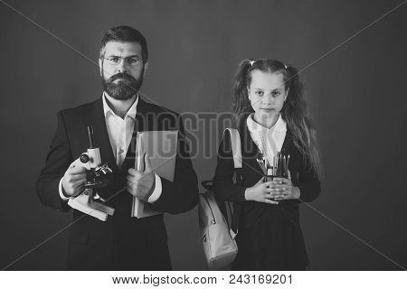 Back To School. Man And Girl And School Uniform. Teacher And Schoolgirl With Serious Faces On Green 