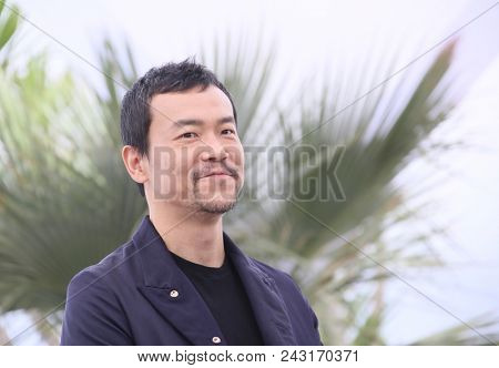 Liao Fan attends the photocall for 'Ash Is The Purest White (Jiang Hu Er Nv)' during the 71st annual Cannes Film Festival at Palais des Festivals on May 12, 2018 in Cannes, France. 