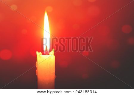 Single Lit Candle With Quite Flame- Bokeh Background