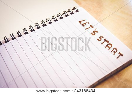 Spiral Notebook On The Abstract Wooden Table