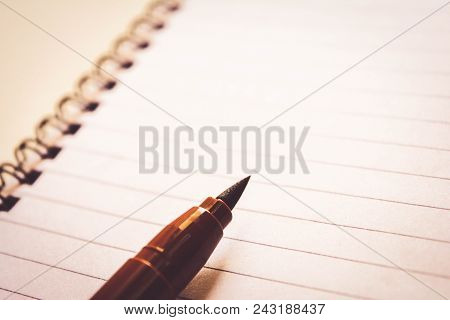Spiral Notebook On The Abstract Wooden Table