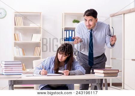 Male lecturer giving lecture to female student