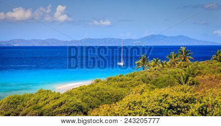 Seaside view from a small island in BVI with a sailboat