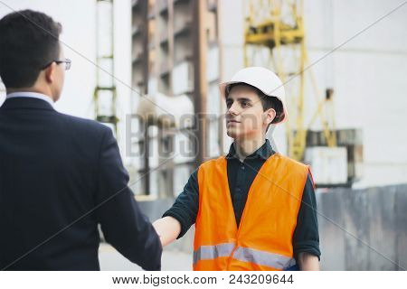 Boss Or Chief Handshaking With Workers Engineers And Giving Salary In An Envelope. Good Job. Busines